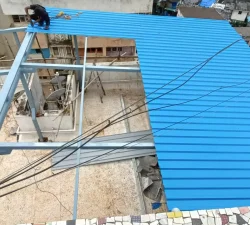 Blue metal terrace shed providing shade and protection on a roofto