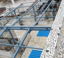 Blue metal terrace shed providing shade and protection on a roofto